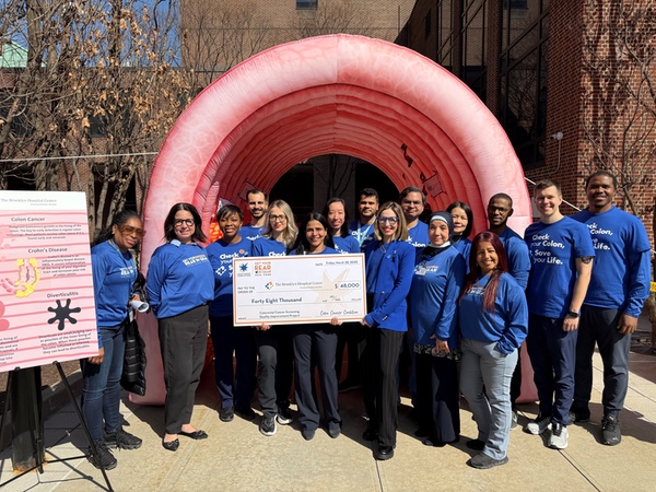 Colon Cancer group displaying donation check